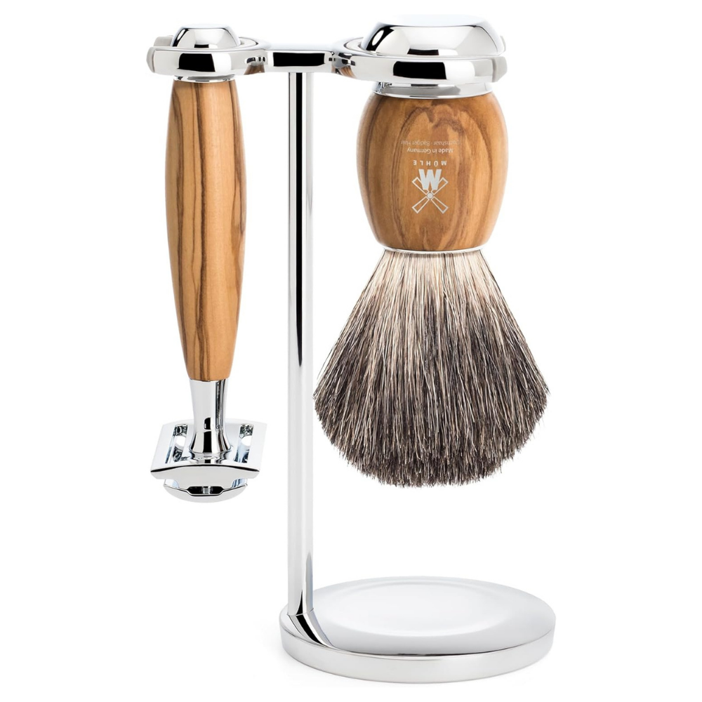 Shaving brush and razor with a wooden handle and silver stand on a white background