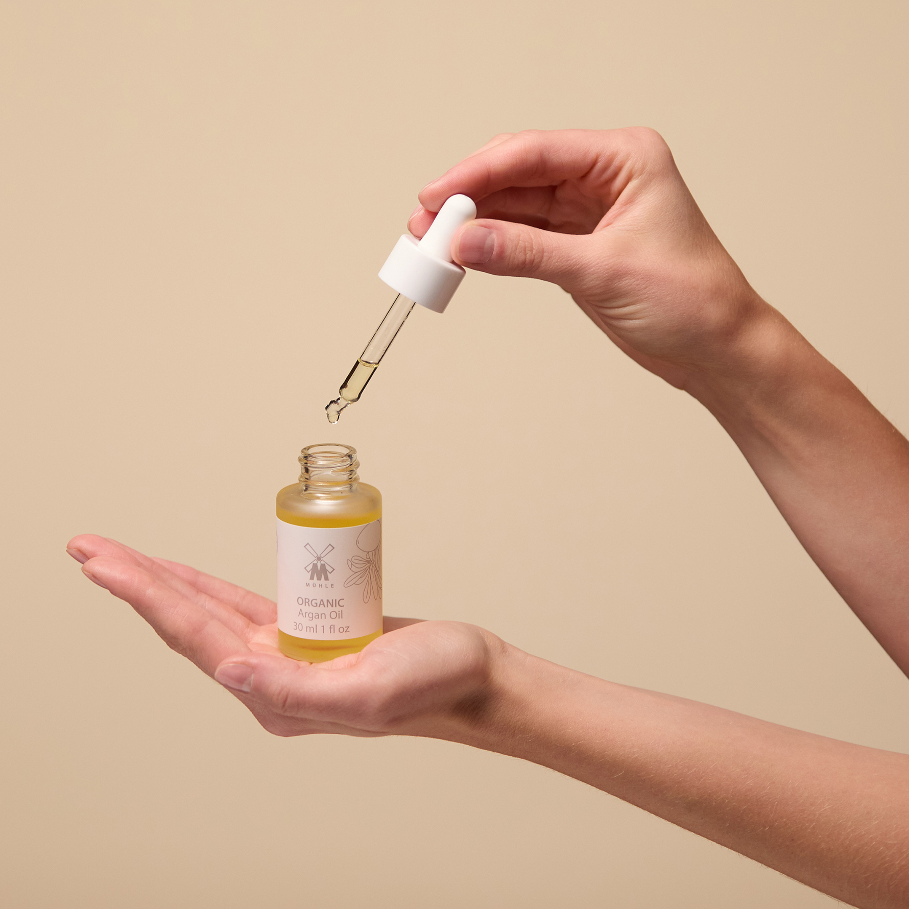 MUHLE Argan Oil opened in a person's hands