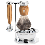 Shaving brush and razor with a wooden handle, silver stand and silver metallic shaving bowl on a white background