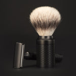 Black shaving brush with bristle head on a black background