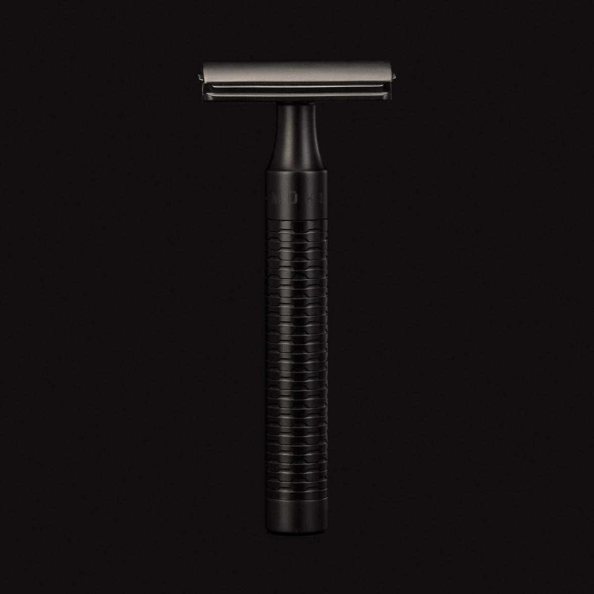 Black safety razor on a black background