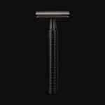 Black safety razor on a black background