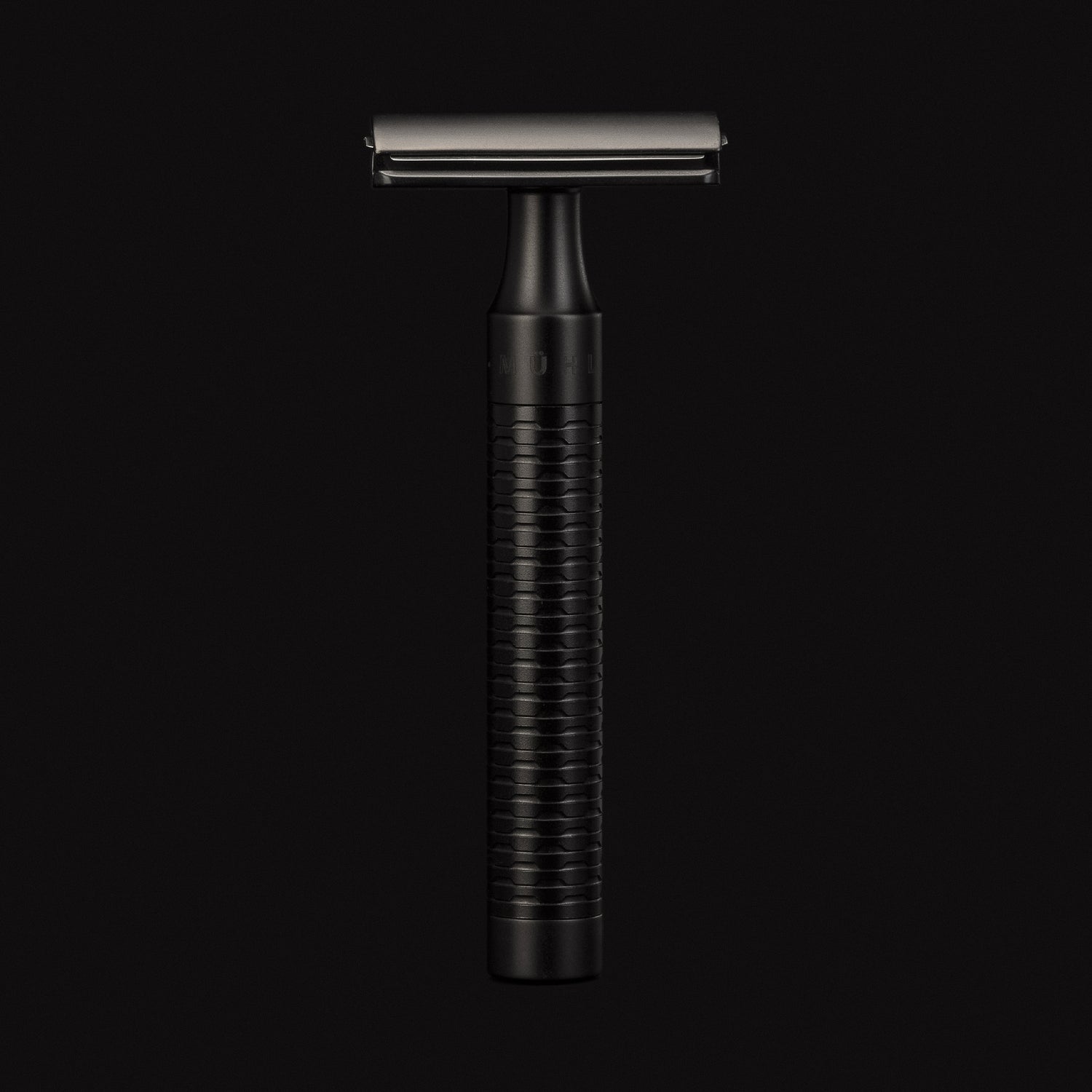 Black safety razor on a black background