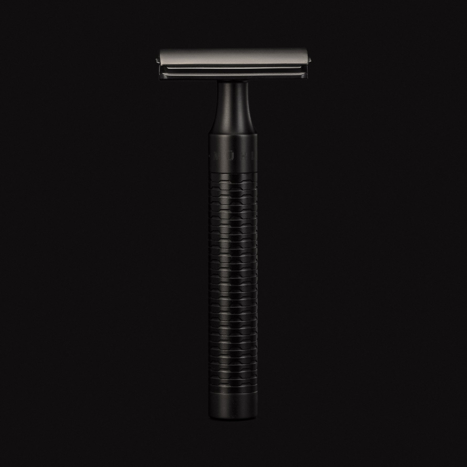 Black safety razor on a black background