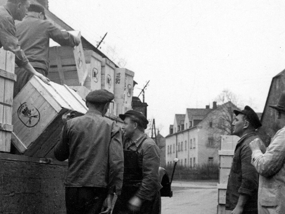 Unloading MUHLE shipping crates in 1945